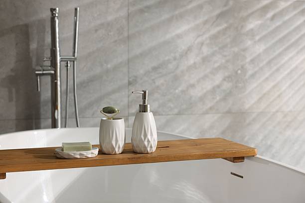 istock Different personal care products and accessories on bath tub in bathroom, space for text 2253063940
