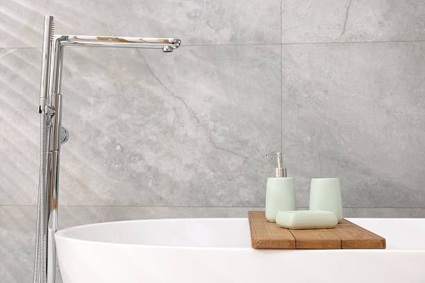 istock Set of bath accessories on tub in bathroom, space for text 2253063942
