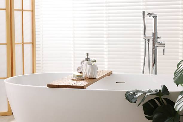 istock Different personal care products on bath tub in bathroom 2253064643