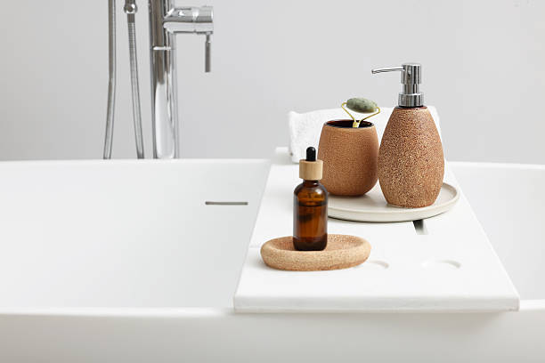 istock Different personal care products and accessories on bath tub in bathroom, space for text 2253064672