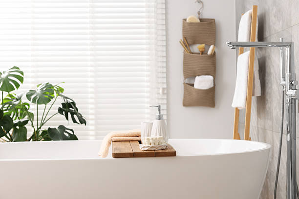 istock Set of different bath accessories and soap on tub in bathroom 2253064692