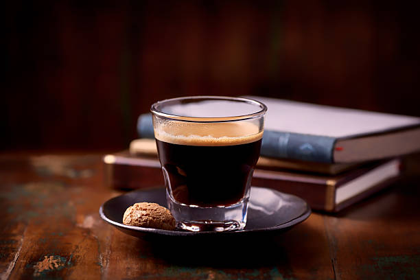 Coffee in glass cup on dark background. Close up.