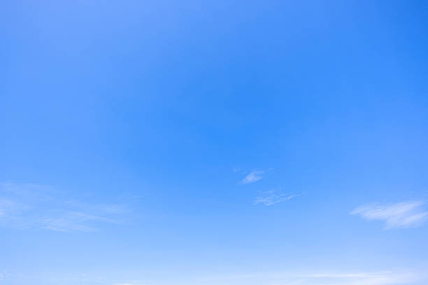 istock Panoramic view of clear blue sky and clouds, Blue sky background with tiny clouds. White fluffy clouds in the blue sky. Captivating stock photo featuring the mesmerizing beauty of the sky and clouds. 2253066441