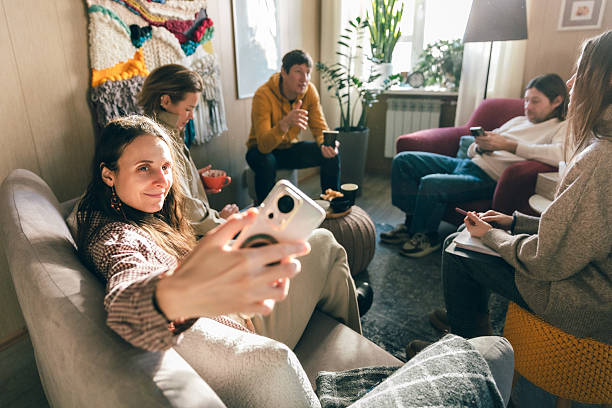 istock Group psychotherapy session with clients sharing emotions and psychologist support indoors 2253066964