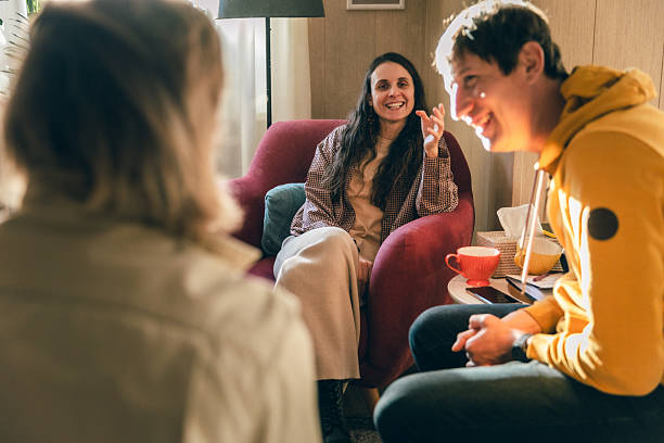 istock Support group conversation with people sharing and smiling in a therapy room 2253067428