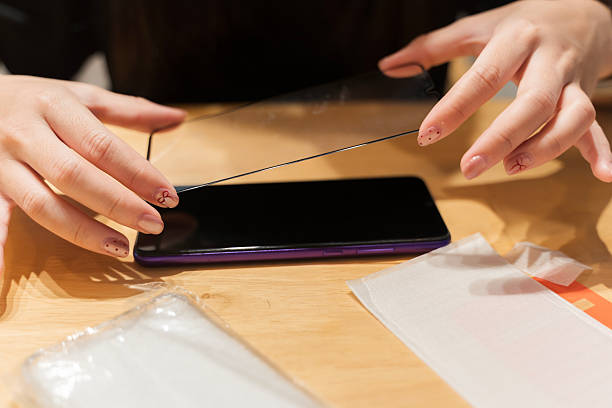 istock Applying Tempered Glass Screen Protector on Smartphone for Protection and Repair Concept 2253067461