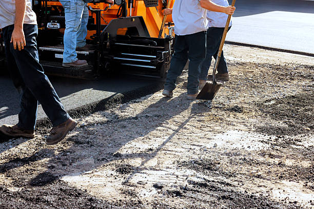istock Workers perform asphalt paving on construction site in busy urban area 2253067895