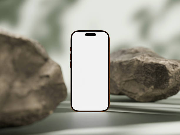 istock Close-up of phone screen mockup against a stone backdrop with natural lighting. 2253070314