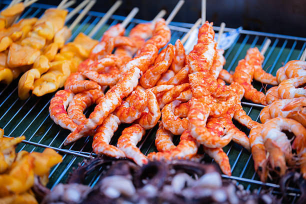 Asian street food market.Seafood (Shrimp) skewers sales on street food market stand.Phuket Island - Thailand.
