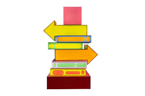 Stacked colorful arrow signs isolated on white background, symbolizing direction, choice, navigation, decision making, business strategy, planning, growth, guidance, and future oriented concepts.