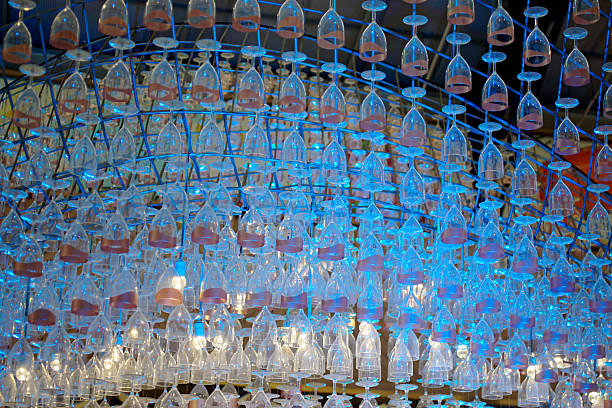 Ceiling decoration, Wine glass hang with structure and blue color lighting decorate ceiling at mall