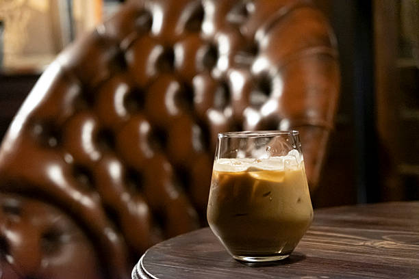 A Refreshing Glass of Iced Latte Coffee on a Warm Wooden Table