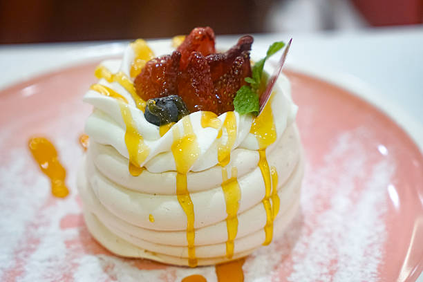 Elegant Pavlova Dessert with Fresh Berries and Syrup
