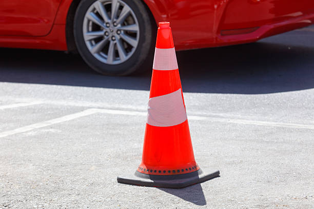 istock A red cone is on the ground in front of a car 2253077052