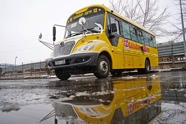 Almaty, Kazakhstan - 12.18.2025 : Parking for yellow school buses. Winter time, snowfall.