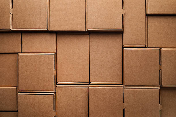 istock Cardboard boxes pattern from craft paper top view. Eco delivery, zero waste, plastic free and disposable package concept. 2253077295
