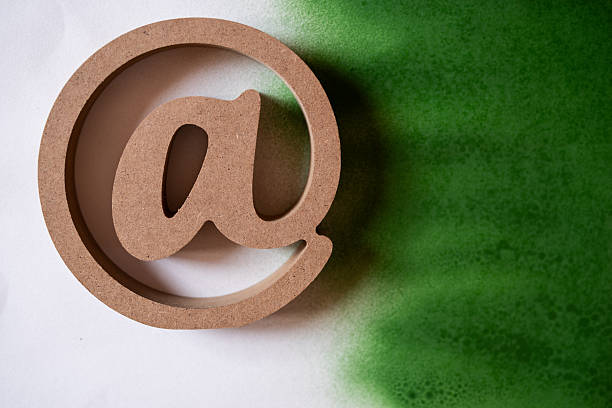 At sign on a white and green background