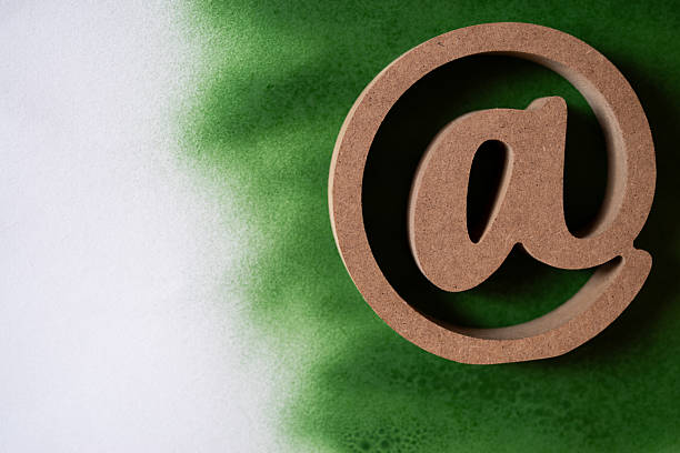 At sign on a white and green background