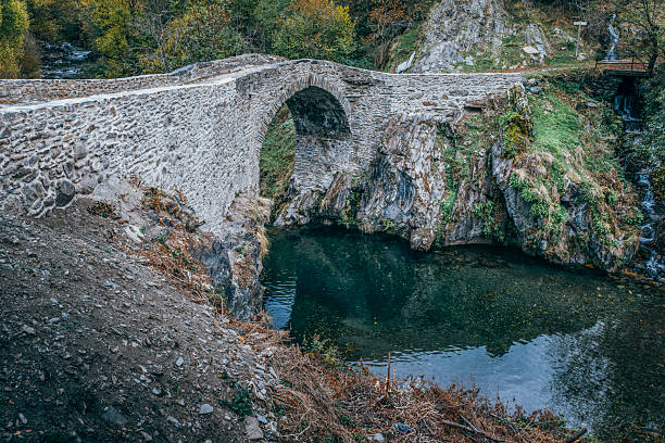 Ancient Romanesque Stone Bridge over River in Catalan Pyrenees Mountains Spain