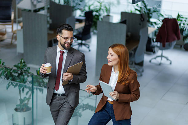 istock Business colleagues talking walking up modern office stairs 2253080585