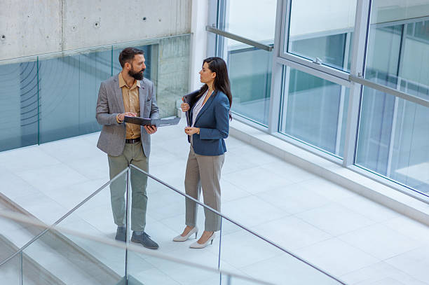 istock Business colleagues discussing project in modern office building 2253080600