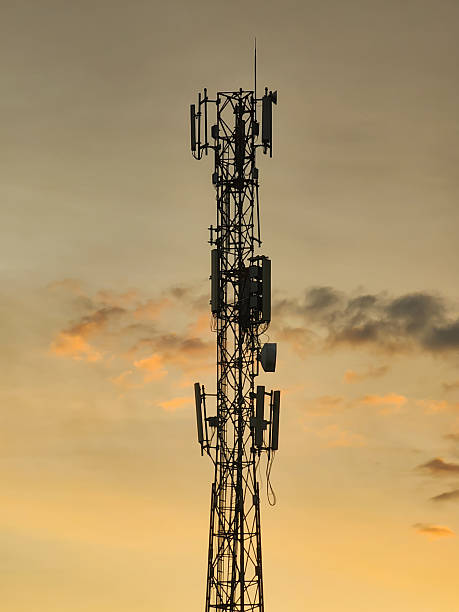 istock Communication Signal Tower Silhouette Against Golden Sunset Sky with Soft Clouds Showing Wireless Technology Infrastructure and Evening Atmosphere 2253081264