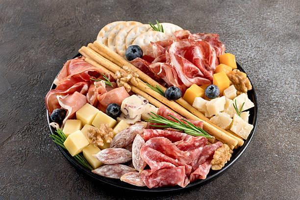 istock Charcuterie board with cured meats, cheese cubes, crackers, nuts breadsticks. Appetizer for party or wine tasting. 2253083700