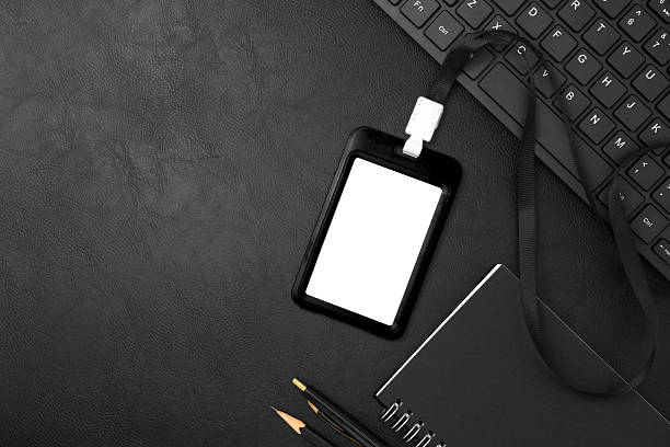 istock Black plastic badge with keyboard on black leather texture background. Template designed for employees of company 2253083842