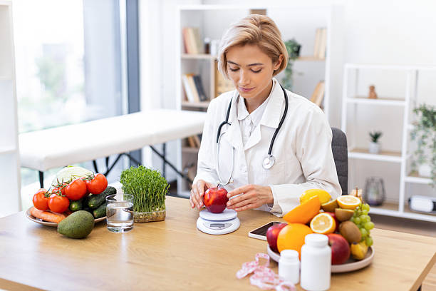 istock Dietitian Weighing Apple 2253085971