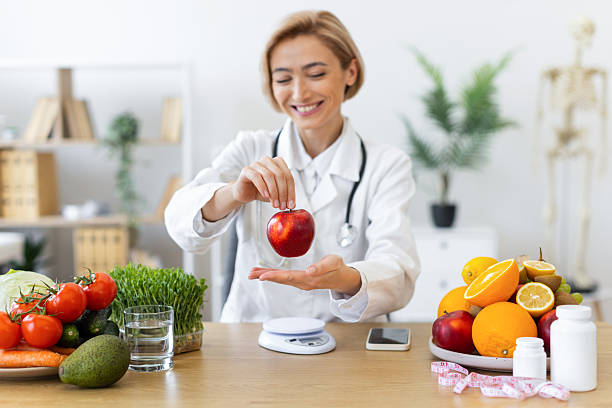 istock Nutritionist with Apple and Fruits 2253085981