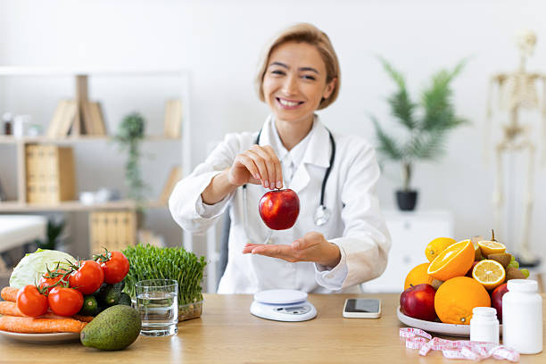 istock Nutritionist with Apple and Fruits 2253085993