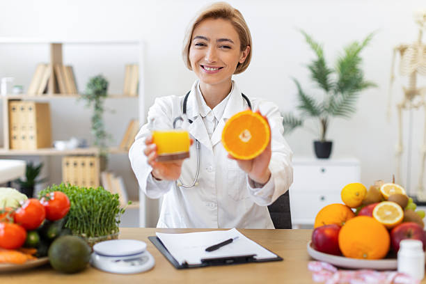 istock Nutritionist with Orange and Juice 2253086034