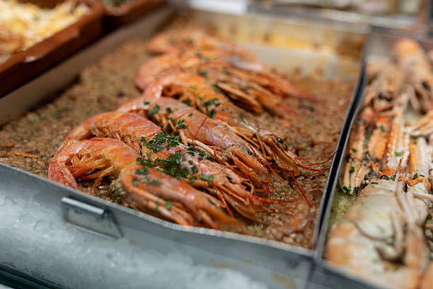 istock Fresh seafood paella with large prawns and langoustines on display in a restaurant 2253086310