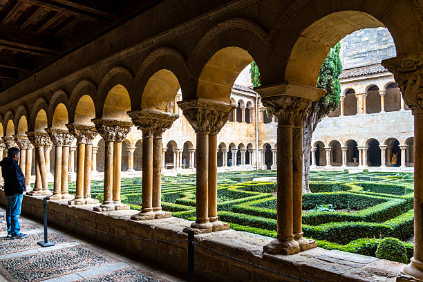A man contemplates the cloister of the Abbey of Santo Domingo de Silos in Burgos, Spain.