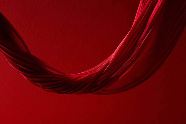 Abstract red background with U-shaped flowing pleated fabric and large copy space.