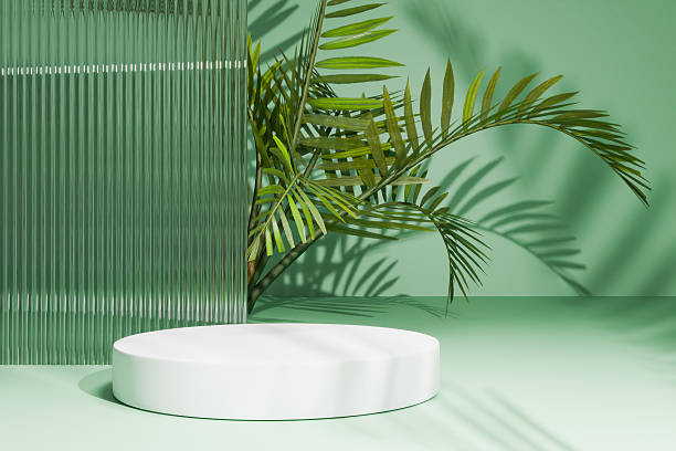 istock Green glass background with palm leaf and white podium 2253086893