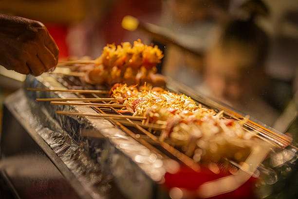 Rolled bacon with mushrooms on barbecue grill.
