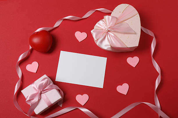 istock Valentine's Day banner with gift boxes surrounded by red hearts on a red background. Perfect for romantic and festive events. 2253089627