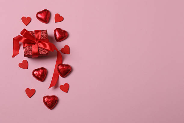 istock Valentine's Day banner with gift boxes surrounded by red hearts on a pink background. Perfect for romantic and festive events. 2253089641