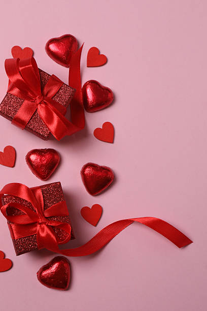 istock Valentine's Day banner with gift boxes surrounded by red hearts on a pink background. Perfect for romantic and festive events. 2253089643