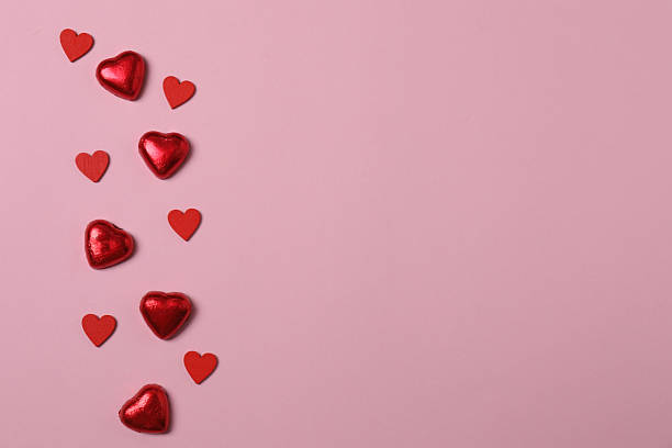 istock Valentine's Day banner with gift boxes surrounded by red hearts on a pink background. Perfect for romantic and festive events. 2253089660