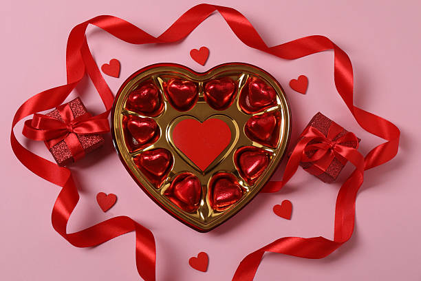 istock Valentine's Day banner with gift boxes surrounded by red hearts on a pink background. Perfect for romantic and festive events. 2253089672