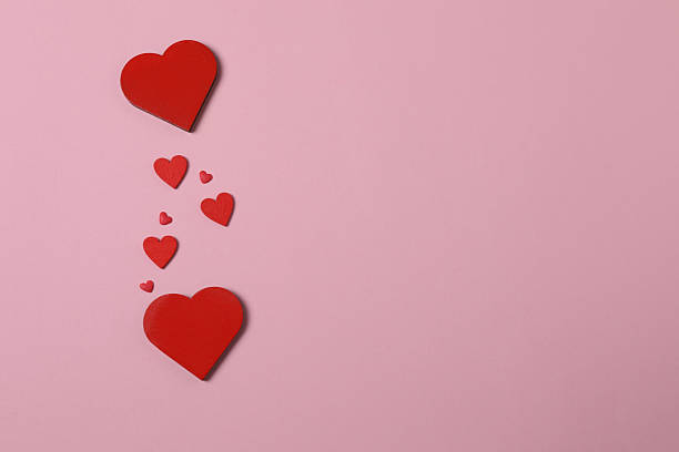 istock Valentine's Day banner with gift boxes surrounded by red hearts on a pink background. Perfect for romantic and festive events. 2253089830