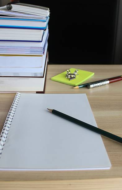 istock Paper, pencil, notebook and books on a study desk. 2253089906