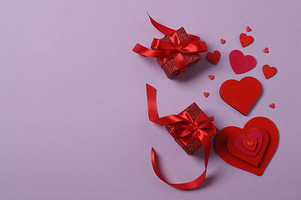 istock Valentine's Day banner with gift boxes surrounded by red hearts on a colorful background. Perfect for romantic and festive events. 2253090187