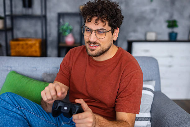 istock Casual Gamer Enjoying Console Game at Home 2253096097