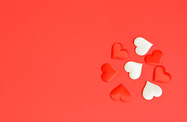 istock Scattered Red and White Hearts on a Vibrant Red Background valentine's day background copy space 2253105049