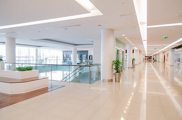 istock Bright Empty Corridor in Modern Shopping Mall Interior with Glass Railings and Copy Space 2253106434