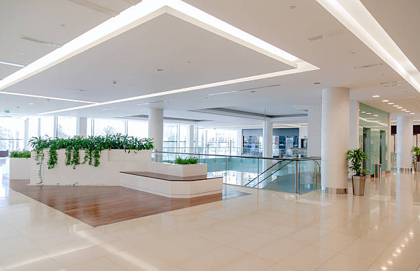istock Bright Empty Corridor in Modern Shopping Mall Interior with Glass Railings and Copy Space 2253106464