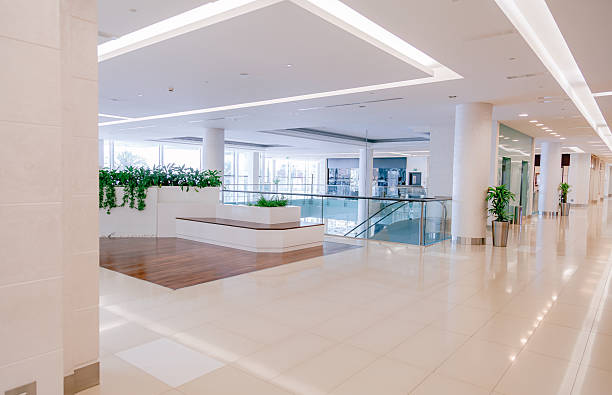 istock Bright Empty Corridor in Modern Shopping Mall Interior with Glass Railings and Copy Space 2253106490